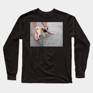 A cute puppy pug between a woman's legs in pink shoes Long Sleeve T-Shirt